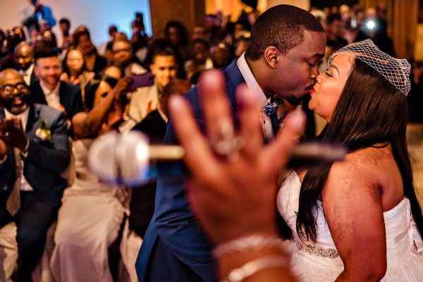 Bride and groom first kiss during ceremony at The Metropolitan Caterers in Glen Cove